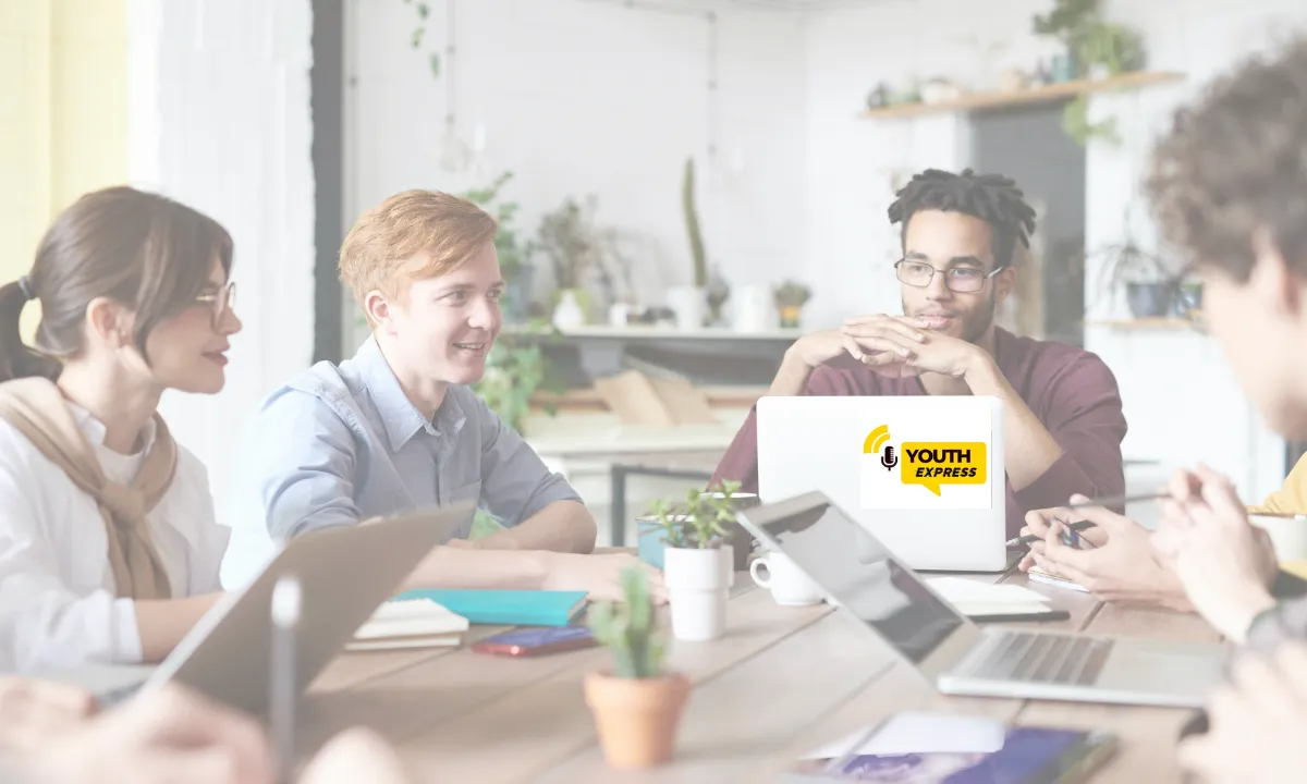 Youth Express feature image for the About page, young professionals seated across a table from each other.