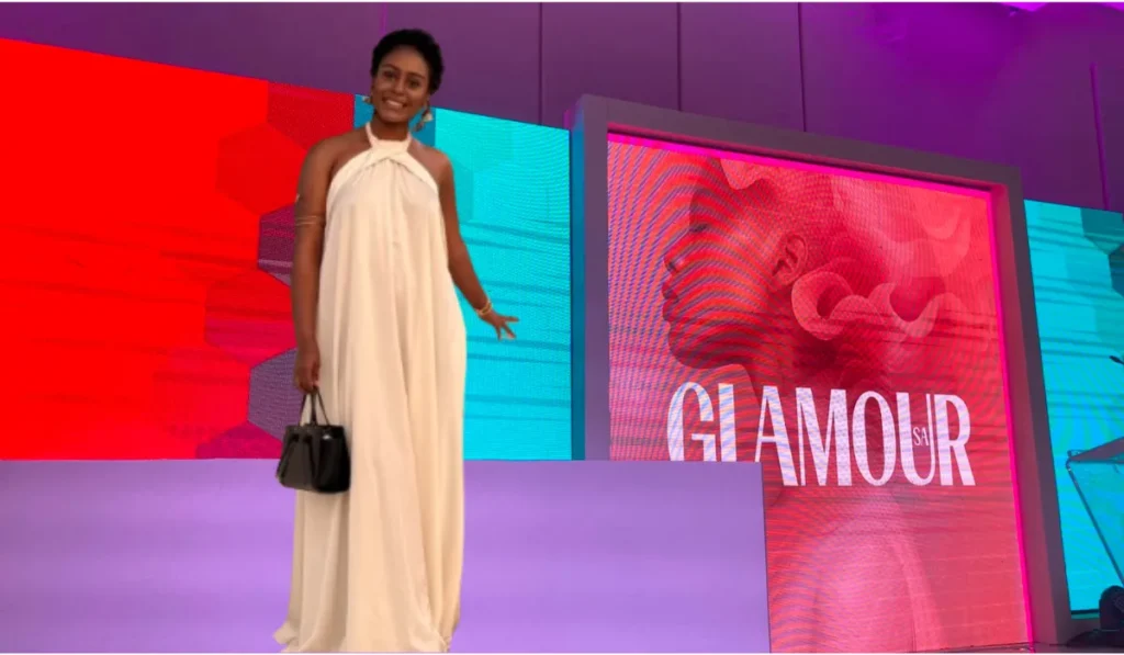 glamour feature image of writer Damatria wearing a flowing white evening gown